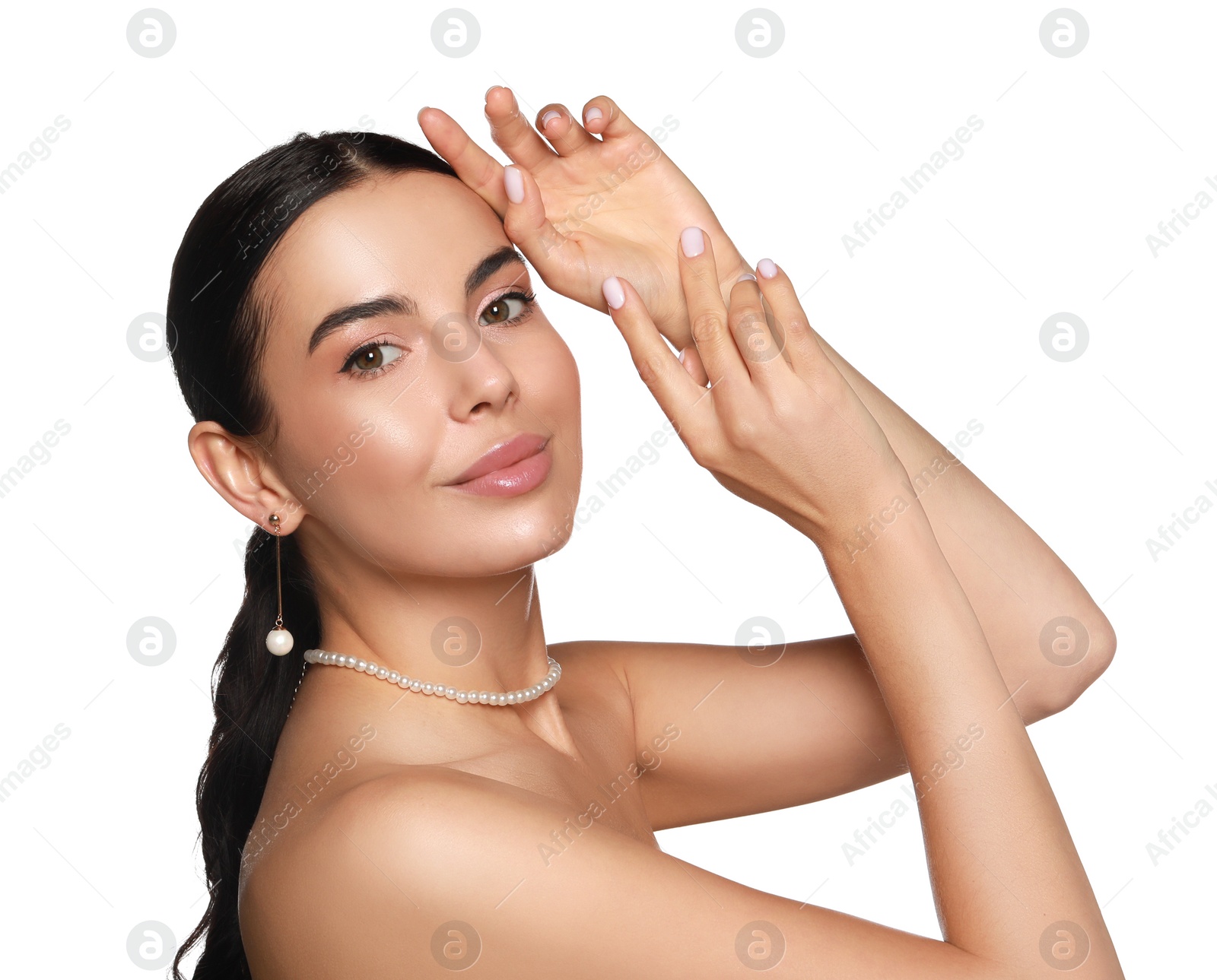 Photo of Young woman wearing elegant pearl jewelry on white background