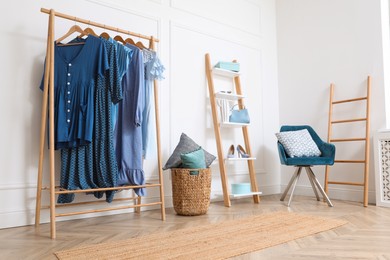 Photo of Dressing room with stylish clothes, shoes and accessories. Elegant interior design