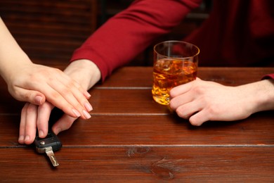 Woman stopping drunk man from taking car keys, closeup. Don't drink and drive concept