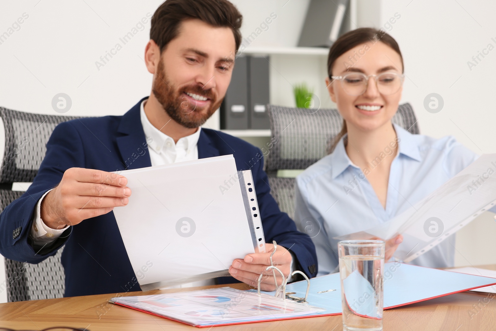 Photo of Businesspeople working together with documents in office