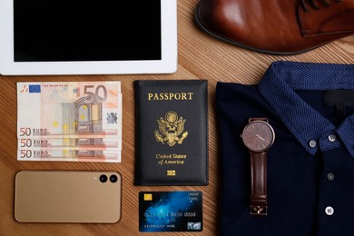 Photo of Business trip stuff on wooden surface, flat lay