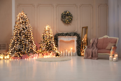 Blurred view of festive room interior with Christmas trees