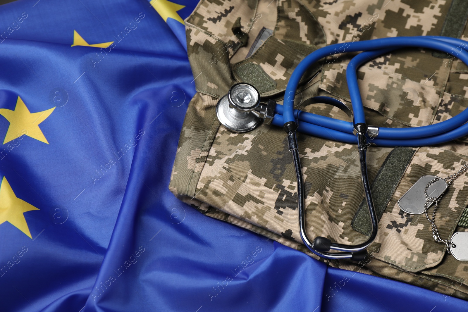 Photo of Stethoscope and military uniform on flag of European Union, above view