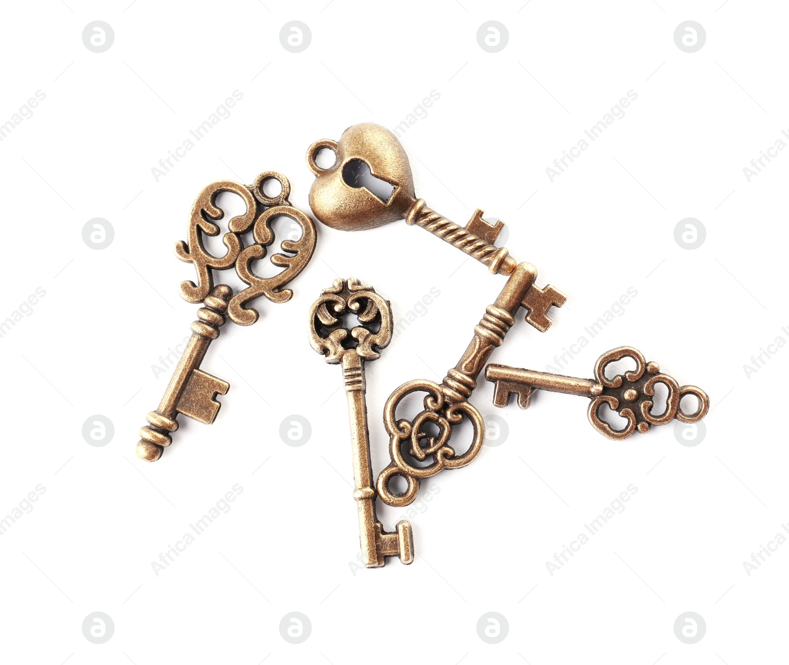 Photo of Bronze vintage ornate keys on white background, top view