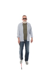 Photo of Mature blind person with long cane walking on white background