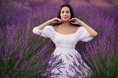 Photo of Portrait of beautiful young woman in lavender field