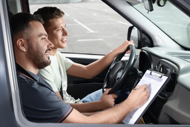 Driving school. Student passing driving test with examiner in car at parking lot
