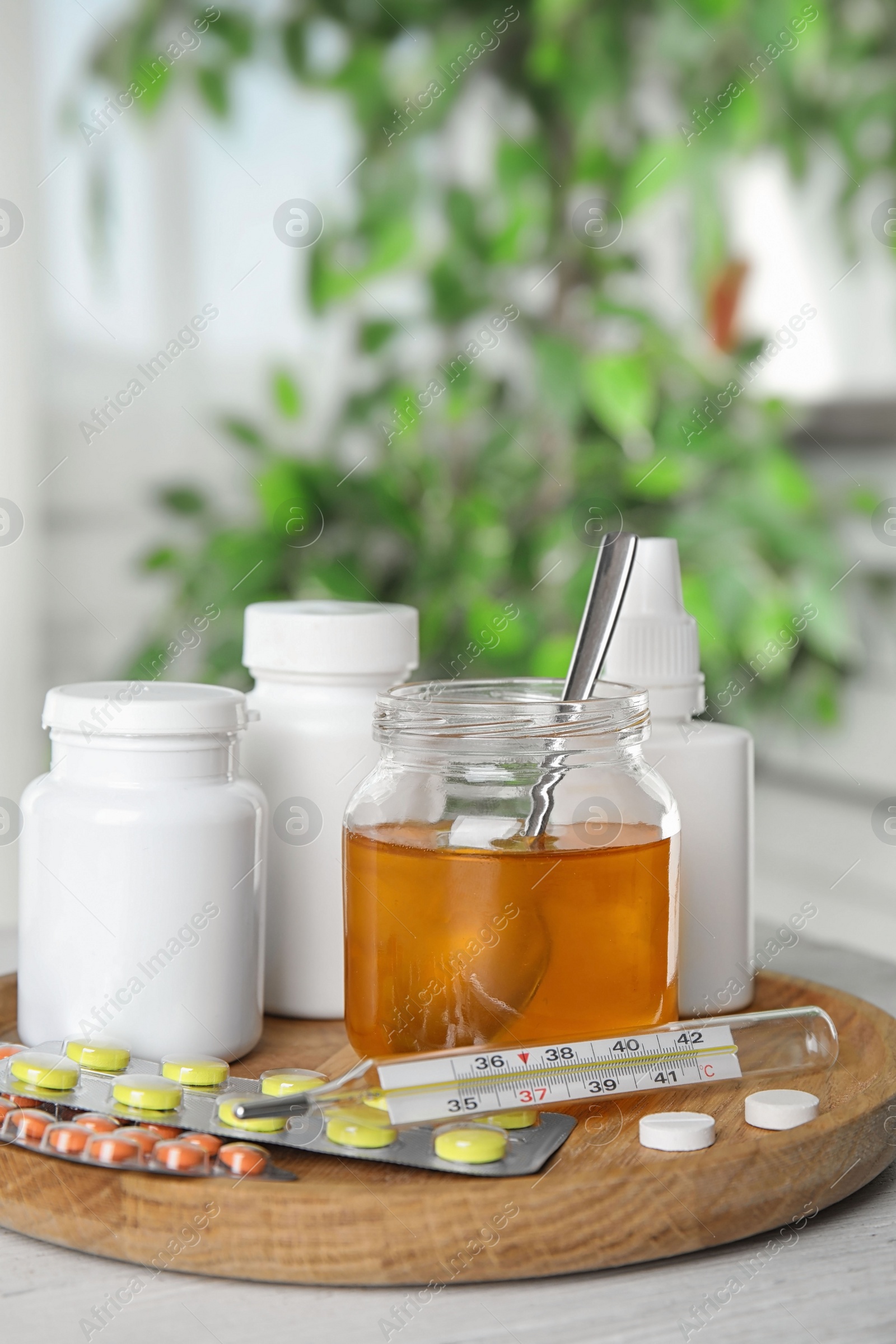 Photo of Honey and different cold remedies on white wooden table