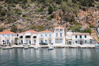 Beautiful view of coastal city with boats on sunny day