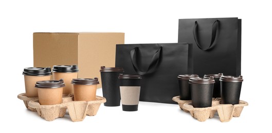 Image of Set with cardboard box, takeaway cups and paper bags on white background