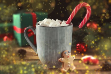 Image of Delicious hot chocolate with marshmallows, candy cane and Christmas cookie on wooden table. Bokeh effect