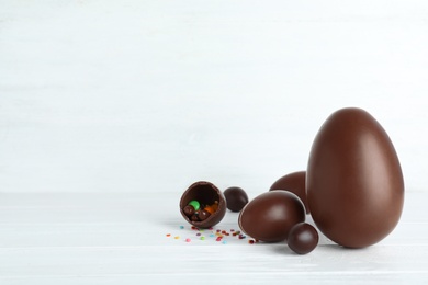 Photo of Composition with chocolate Easter eggs on table. Space for text