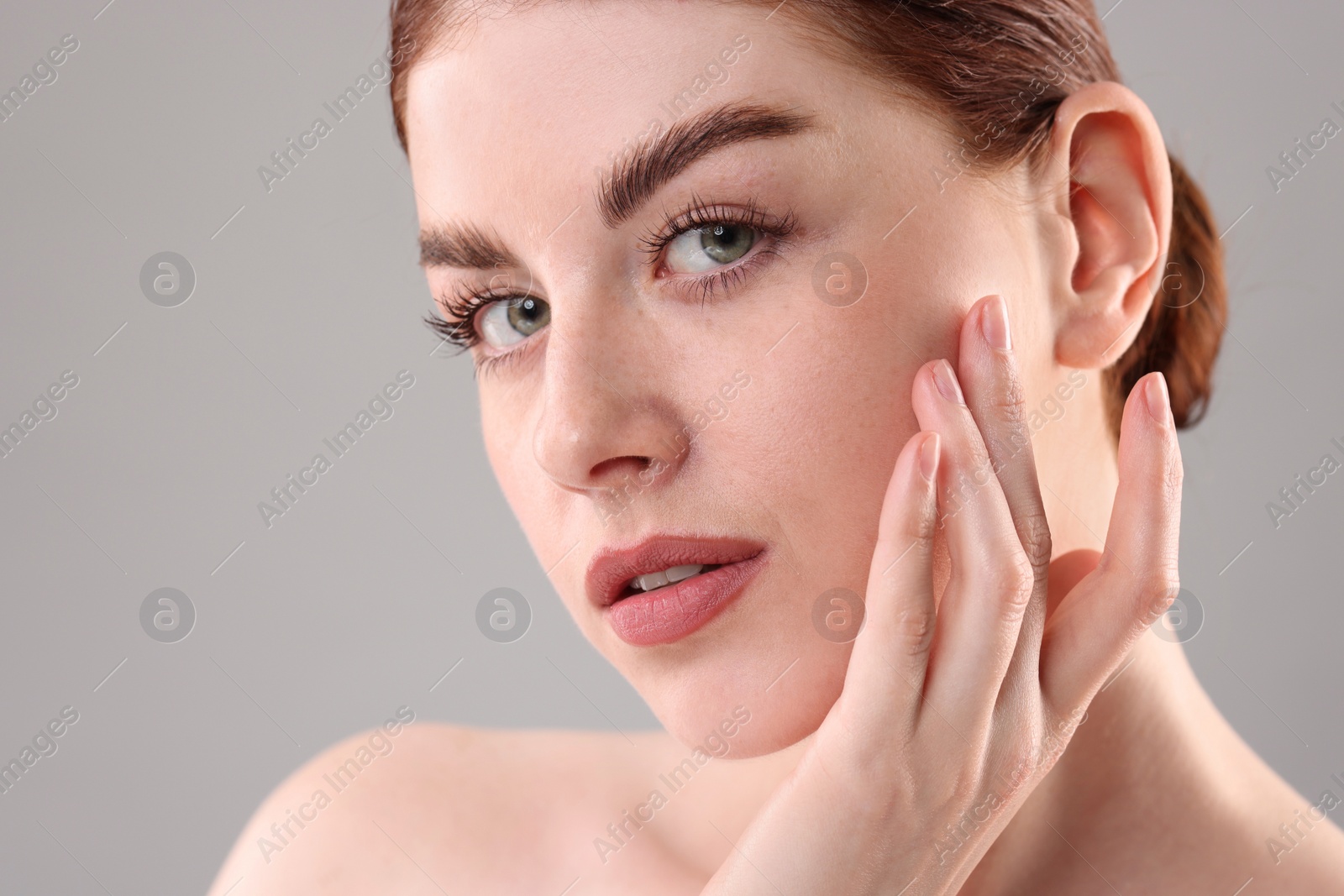 Photo of Portrait of beautiful woman on grey background, closeup