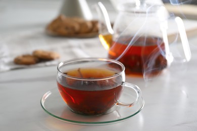 Glass cup of hot tea served for breakfast on white table