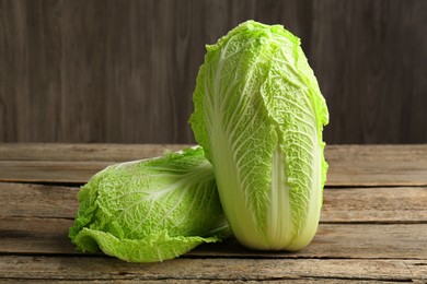 Photo of Fresh ripe Chinese cabbages on wooden table