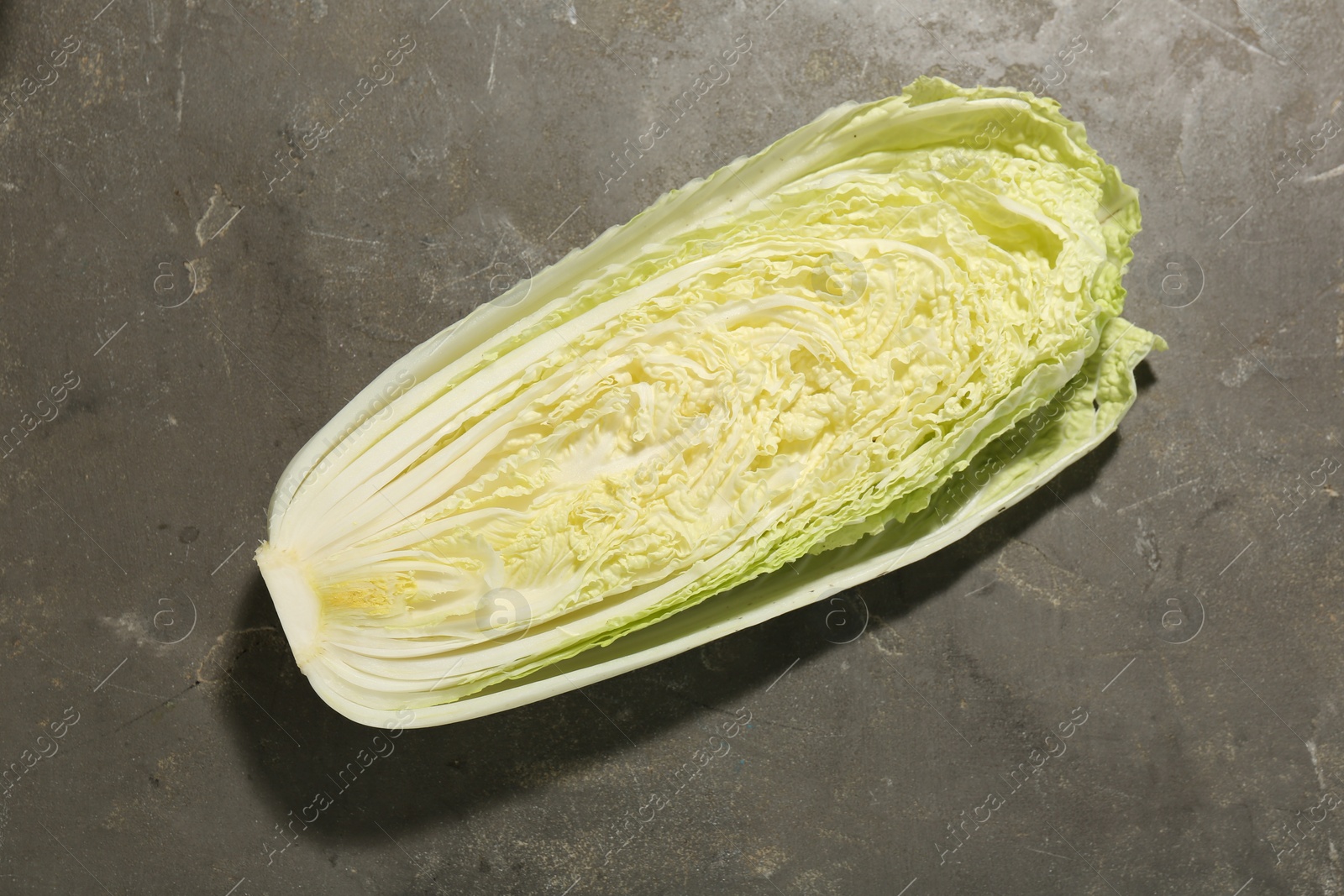 Photo of Fresh ripe Chinese cabbage on gray textured table, top view