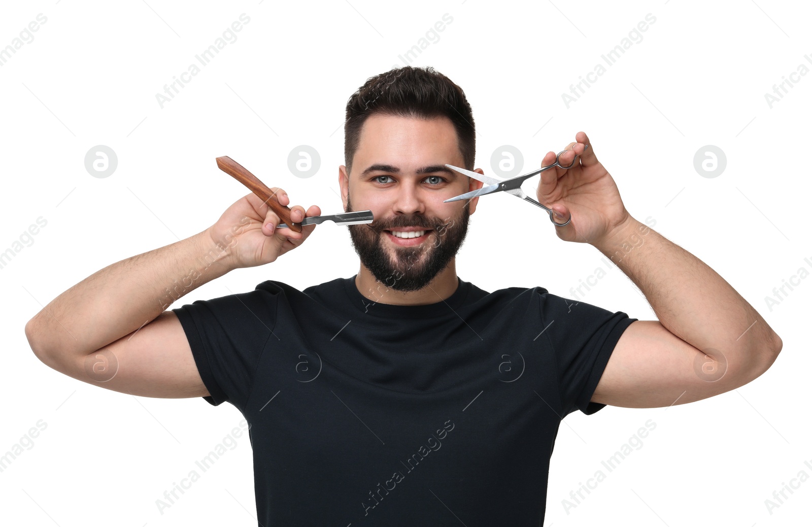 Photo of Handsome young man with mustache holding blade and scissors on white background