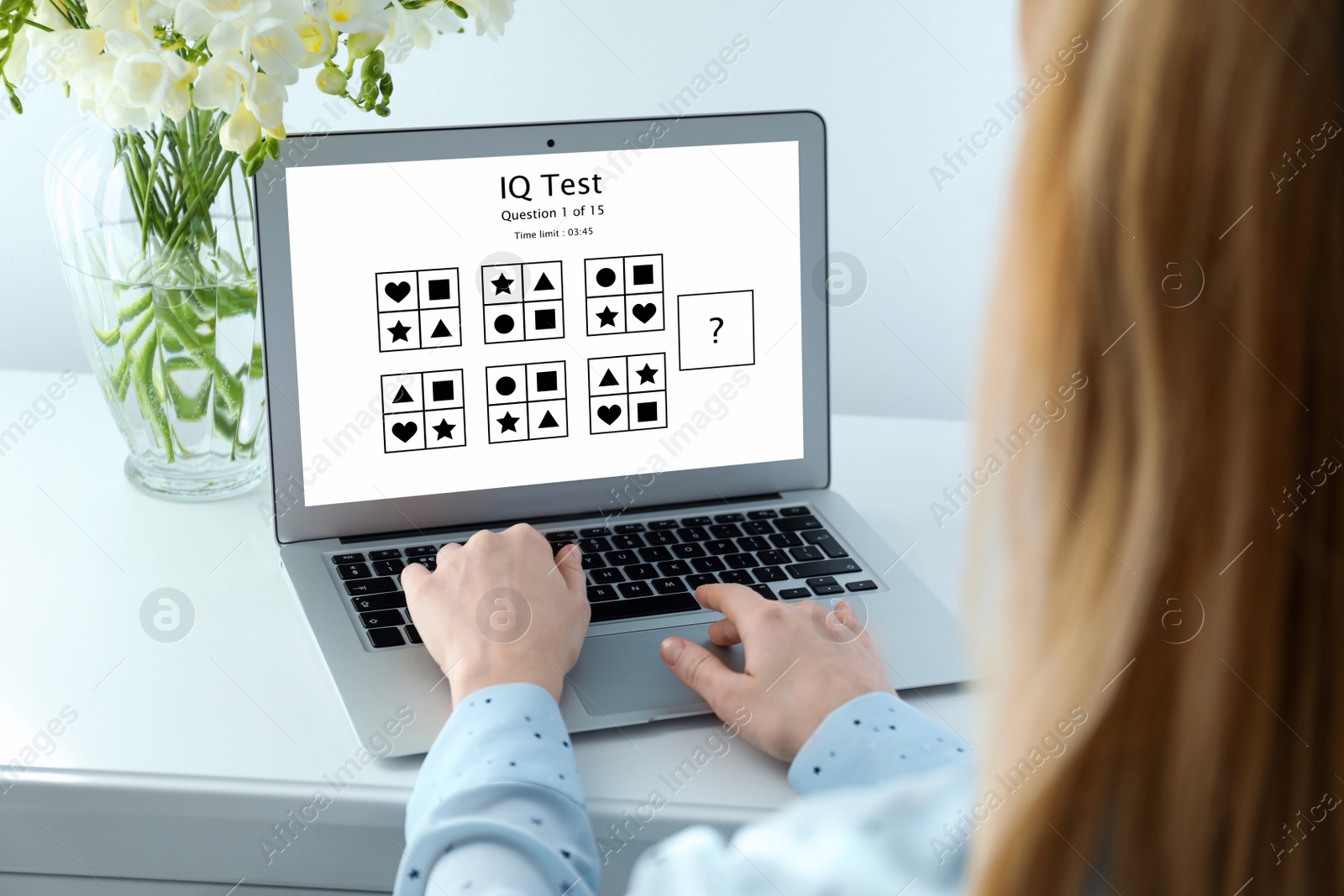 Image of Woman using laptop for taking IQ test indoors, closeup