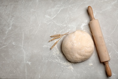 Photo of Flat lay composition with raw dough on grey background
