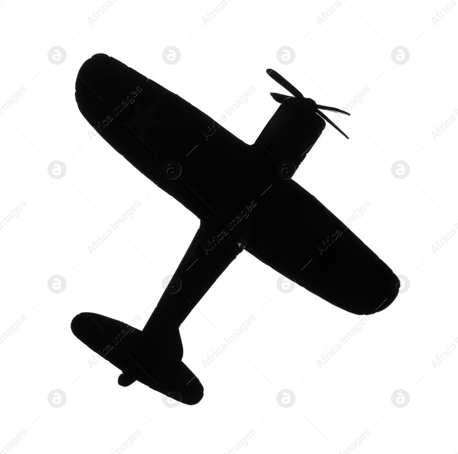 Photo of Dark silhouette of vintage toy military airplane on white background