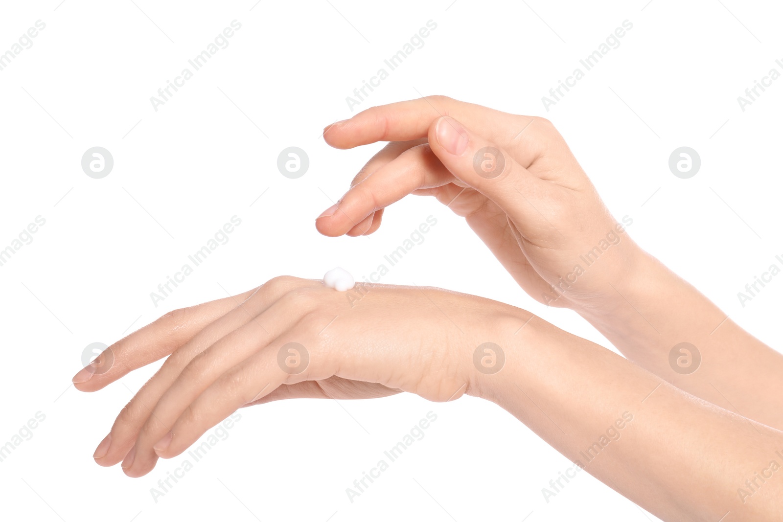 Photo of Young woman applying cream on her hands, closeup. Beauty and body care