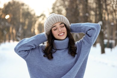 Portrait of smiling woman in snowy park