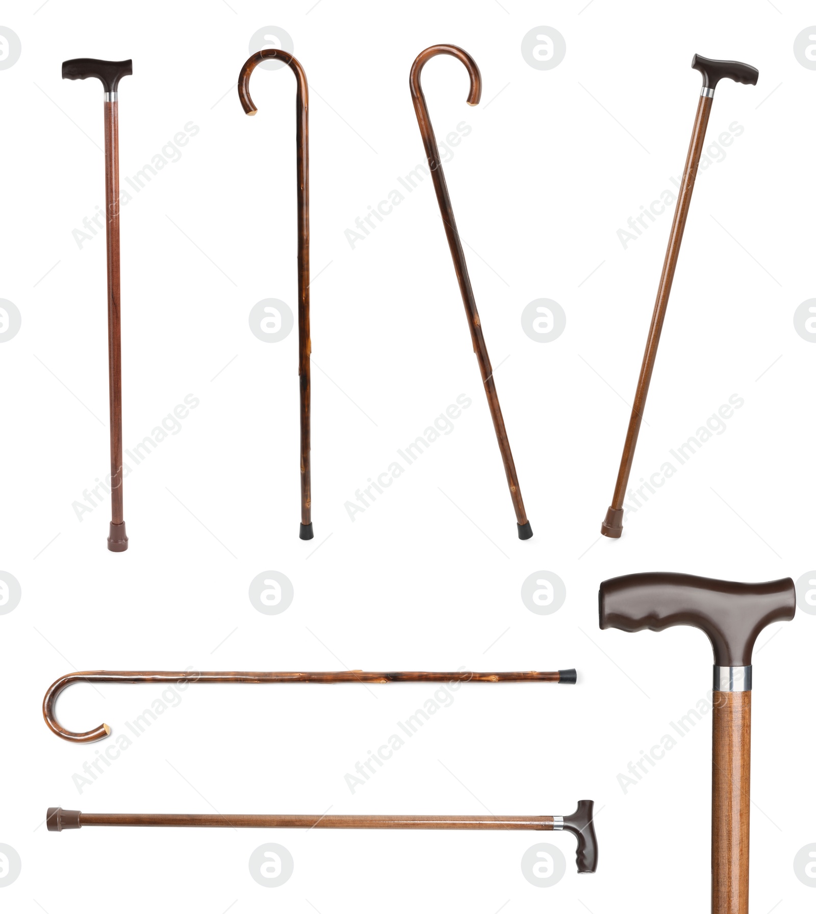 Image of Set with elegant wooden walking canes on white background