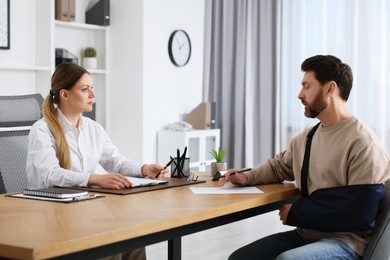 Photo of Injured man having meeting with lawyer in office