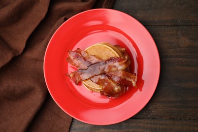 Photo of Delicious pancakes with bacon and honey on wooden table, top view