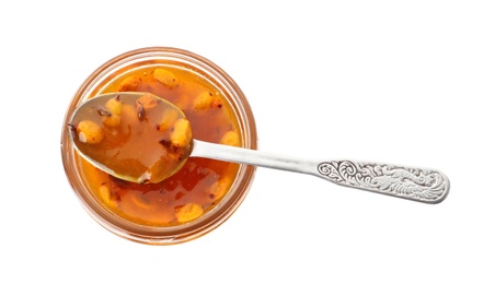 Delicious sea buckthorn jam in jar and spoon isolated on white, top view