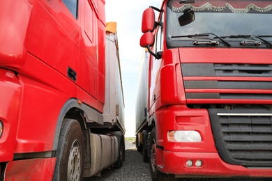 Photo of Modern red trucks parked on road, closeup