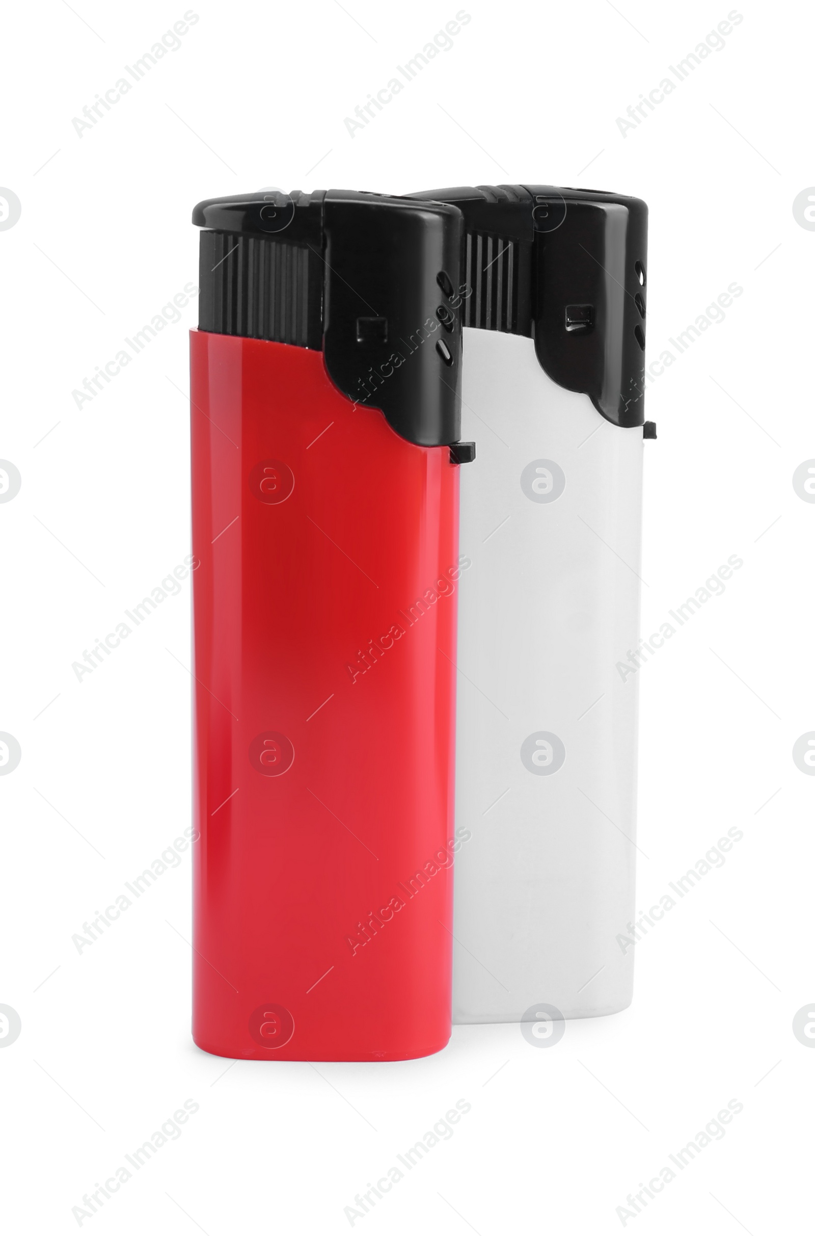 Photo of Stylish small pocket lighters on white background