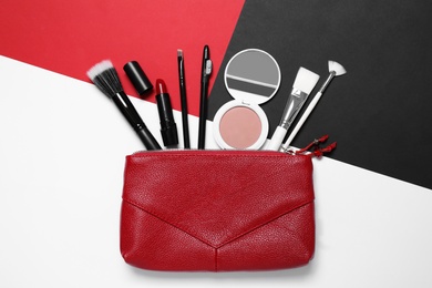 Different makeup products and bag on color background, flat lay