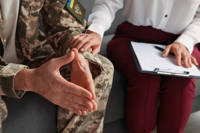 Psychologist supporting military officer in office, closeup