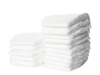 Photo of Stacks of baby diapers isolated on white