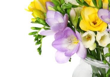 Photo of Bouquet of fresh freesia flowers in vase on white background, closeup
