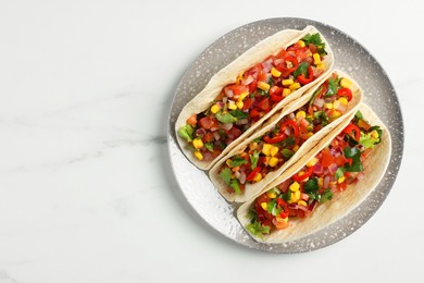 Photo of Tasty tacos with vegetables on white marble table, top view. Space for text