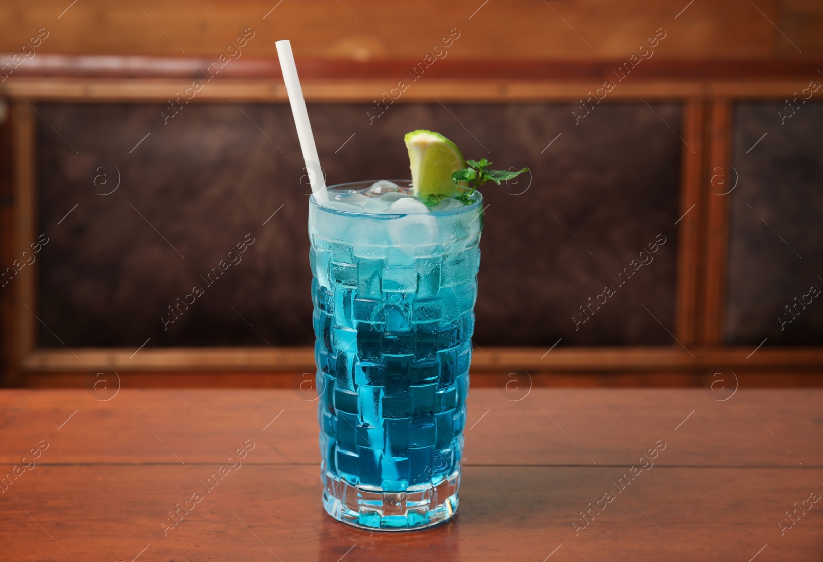 Photo of Glass with delicious cocktail on table in cafe