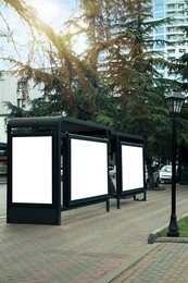 Photo of Blank advertising boards on transport stop. Space for design