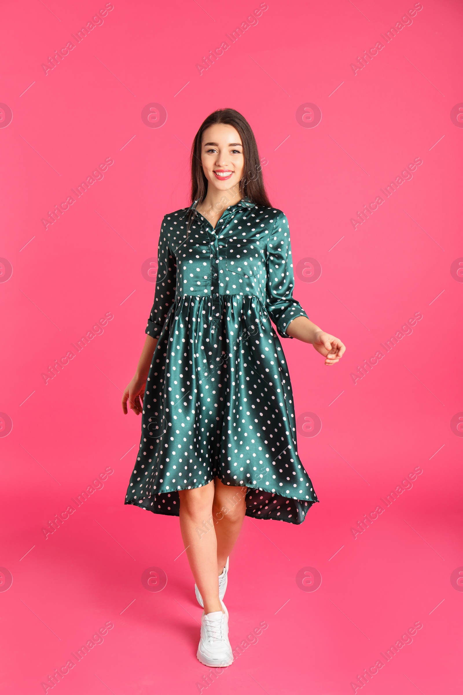 Photo of Portrait of beautiful young woman in stylish dress on color background