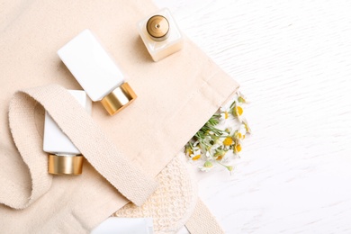 Photo of Flat lay composition with chamomile flowers and cosmetic products on white table
