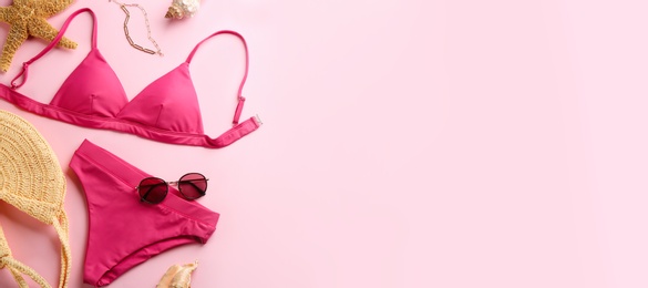 Photo of Beautiful bikini and beach accessories on pink background, flat lay. Space for text