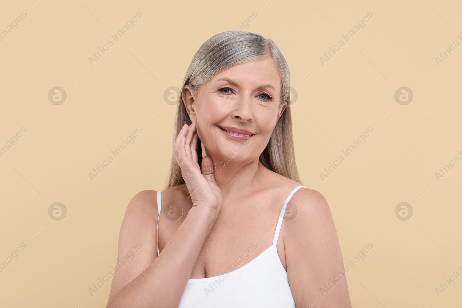 Photo of Portrait of beautiful senior woman on beige background