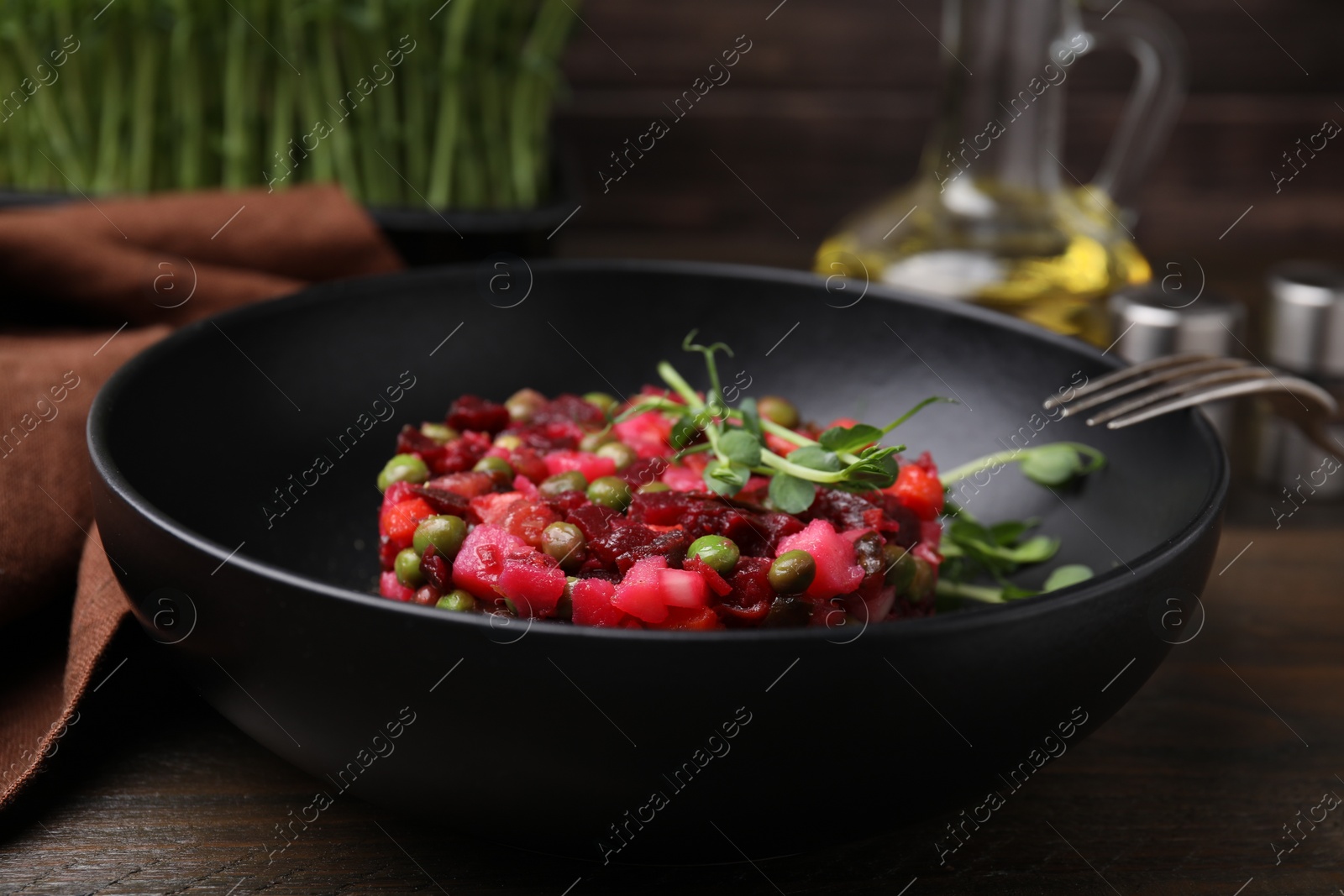 Photo of Delicious vinaigrette salad on wooden table, closeup