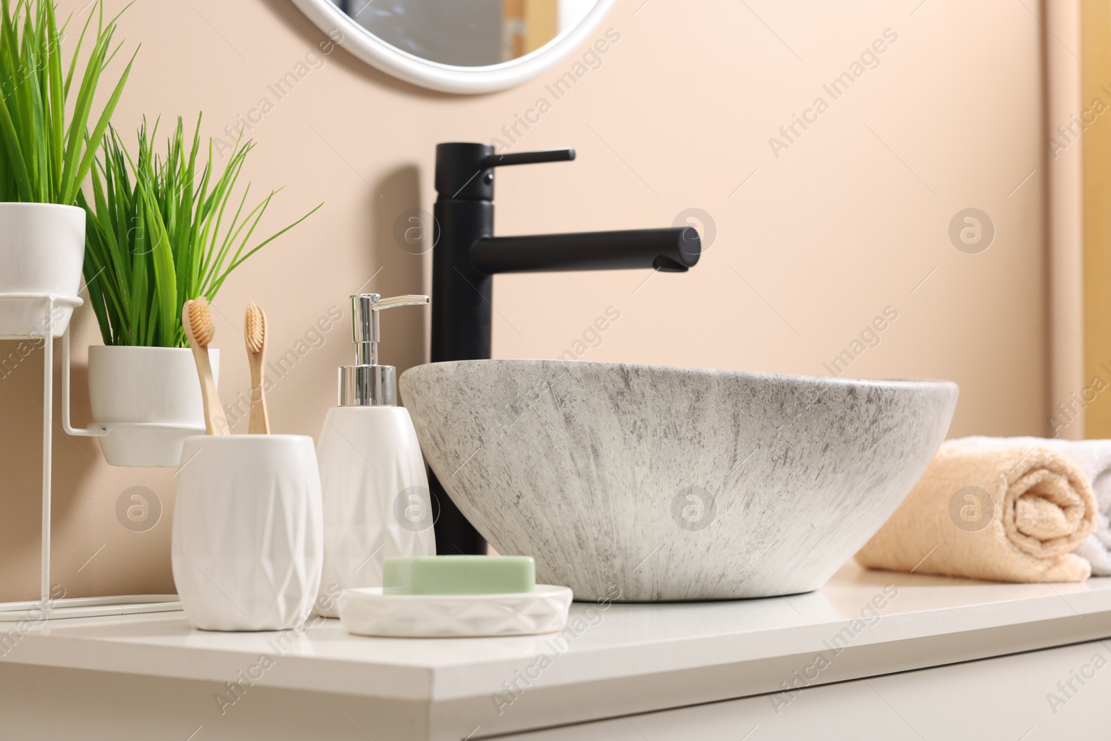 Photo of Different bath accessories and personal care products near sink on bathroom vanity