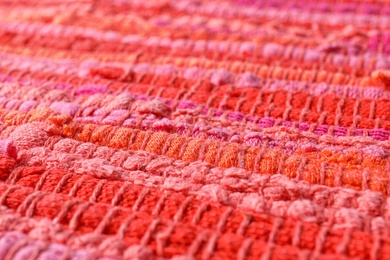 Texture of knitted orange and pink fabric as background, closeup