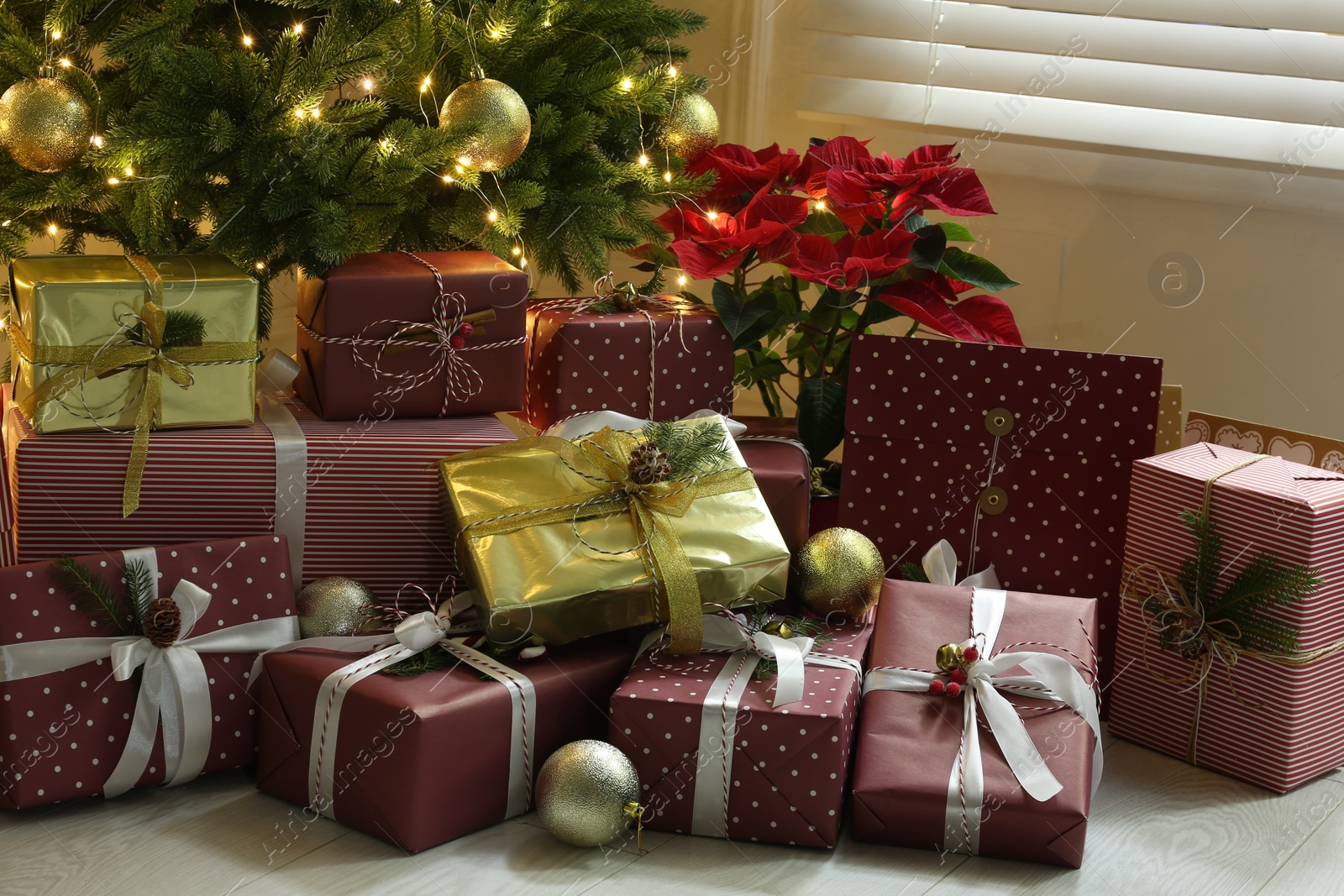 Photo of Many different gifts under Christmas tree indoors