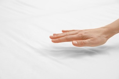 Photo of Woman with orthopedic mattress, closeup. Space for text