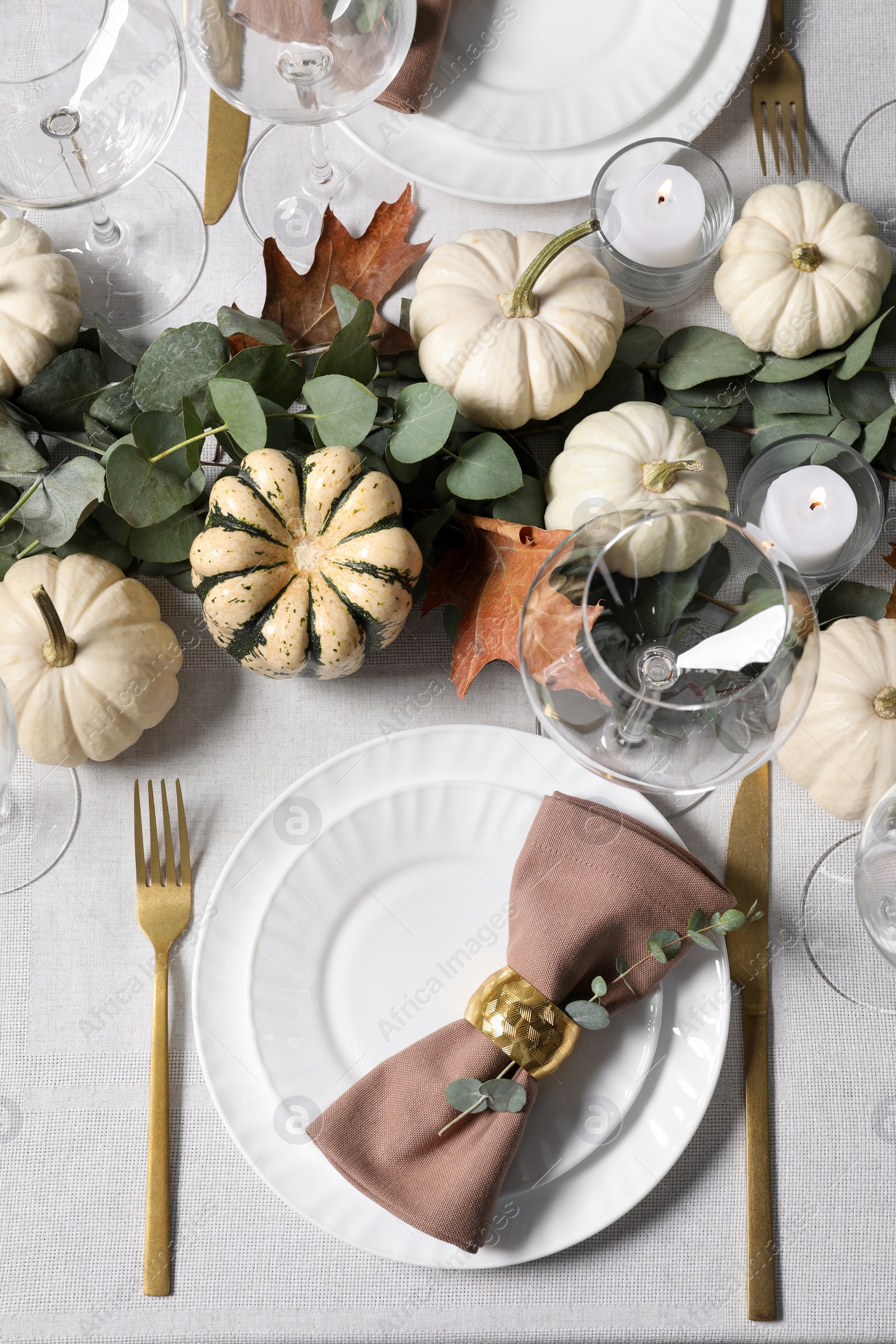 Photo of Beautiful autumn table setting. Plates, cutlery, glasses, pumpkins and floral decor, flat lay