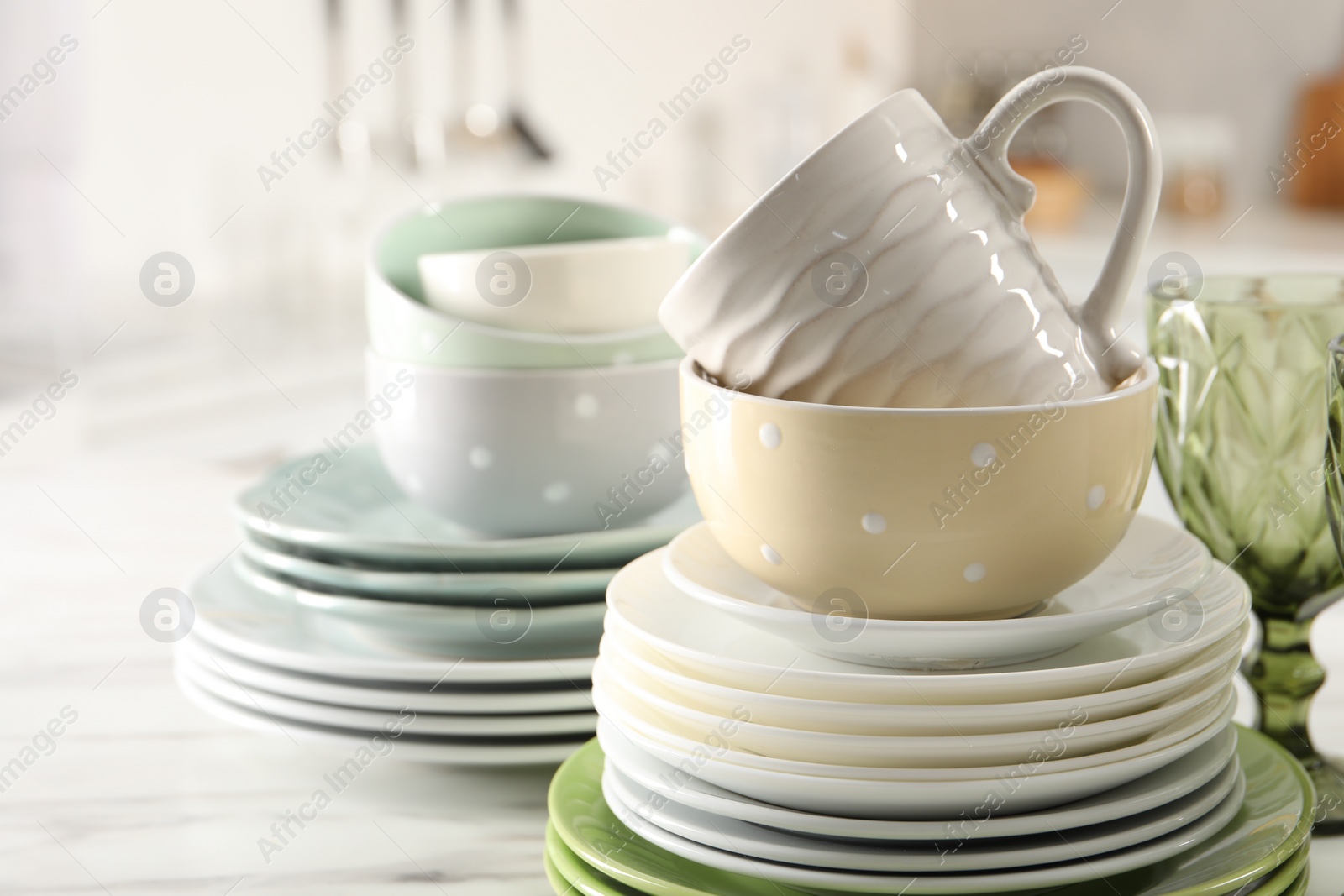 Photo of Many different clean dishware and cup on marble table indoors, closeup